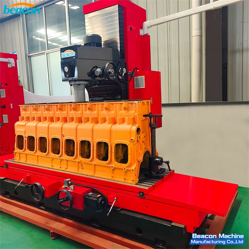 Large orange engine block mounted on T2200 vertical boring milling machine