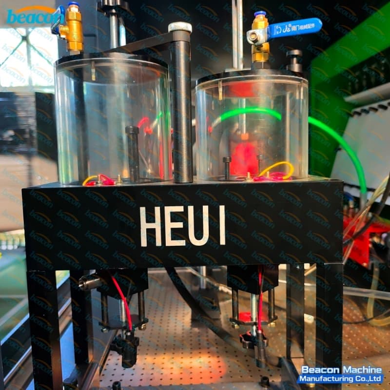 Dual graduated glass beaker testing chamber designed for HEUI hydraulic electronic unit injector validation.