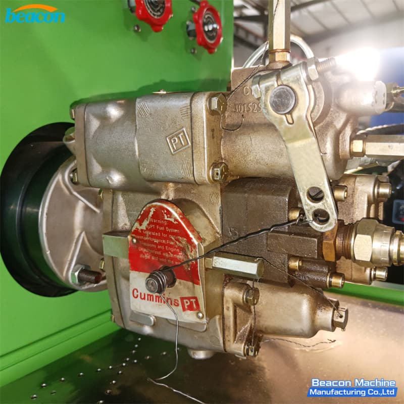 Close-up of Cummins PT gear pump 3015259 mounted on the drive flange with throttle lever and fuel lines. Close-up of Cummins PT gear pump 3015259 mounted on the drive flange with throttle lever and fuel lines.
